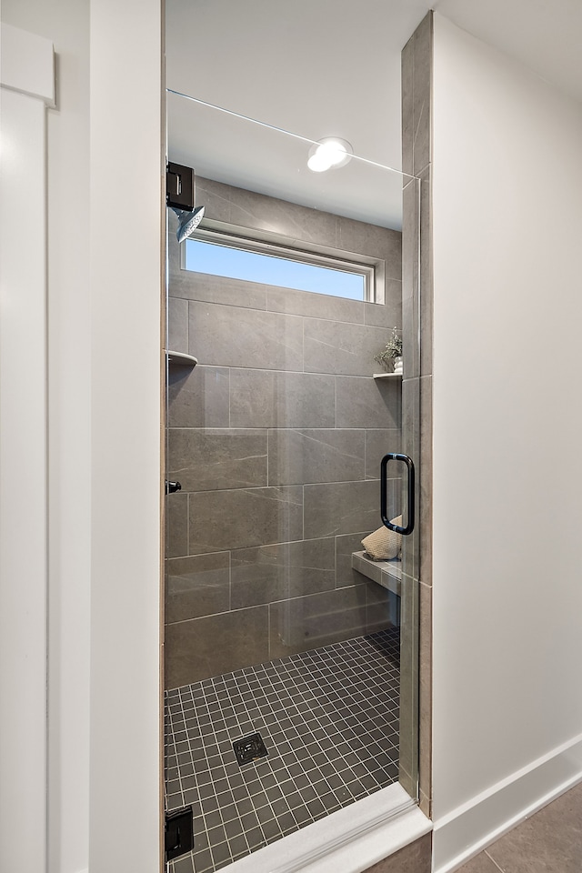 bathroom featuring tile patterned floors and a shower with door