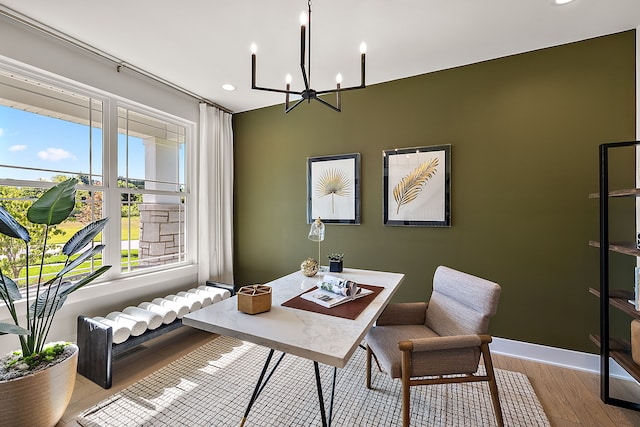 office area with an inviting chandelier and light hardwood / wood-style flooring