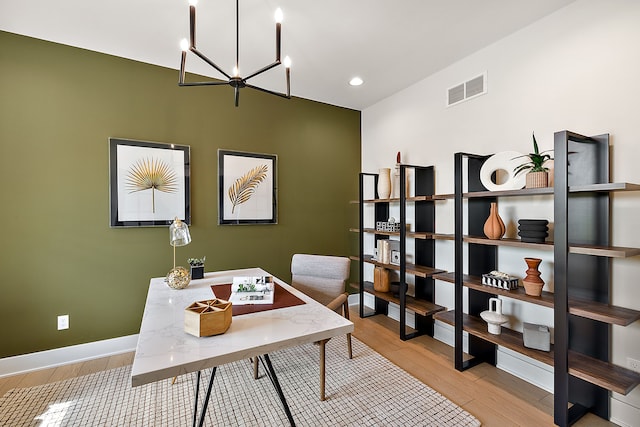 office space featuring light hardwood / wood-style flooring and an inviting chandelier