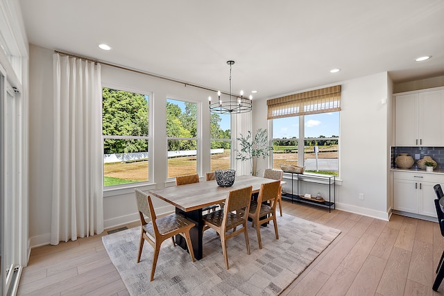 dining room with a chandelier and light wood-type flooring