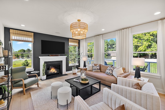 living room featuring a healthy amount of sunlight and light hardwood / wood-style floors