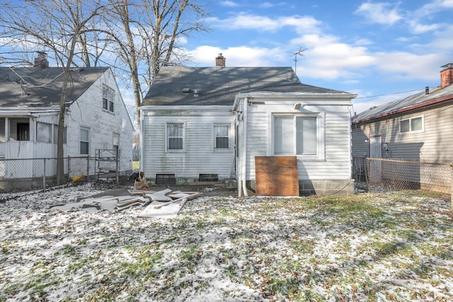 view of snow covered rear of property