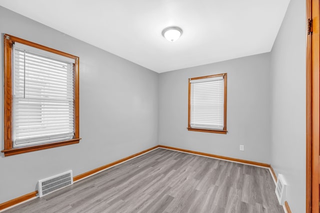 unfurnished room with light hardwood / wood-style floors