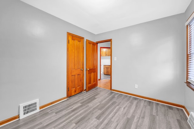 spare room featuring light hardwood / wood-style flooring