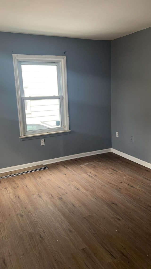 unfurnished room featuring dark hardwood / wood-style flooring