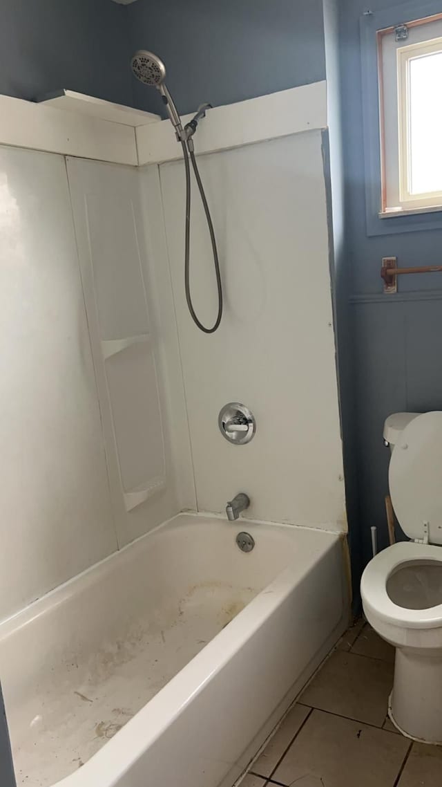 bathroom with toilet, tile patterned flooring, and bathtub / shower combination