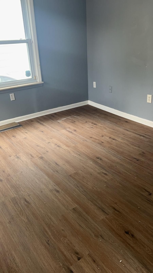 empty room with dark hardwood / wood-style floors