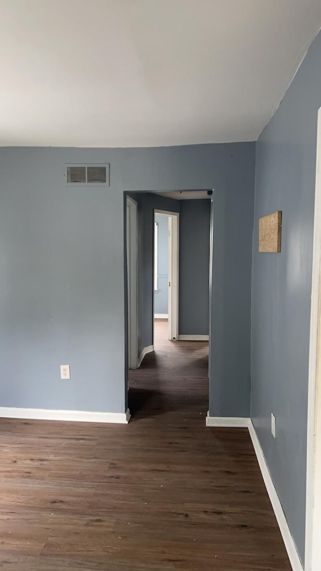 empty room with dark wood-type flooring