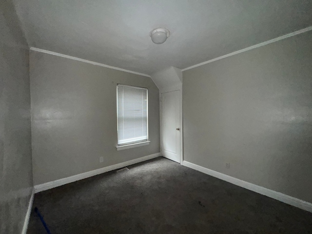 bonus room featuring dark colored carpet and vaulted ceiling