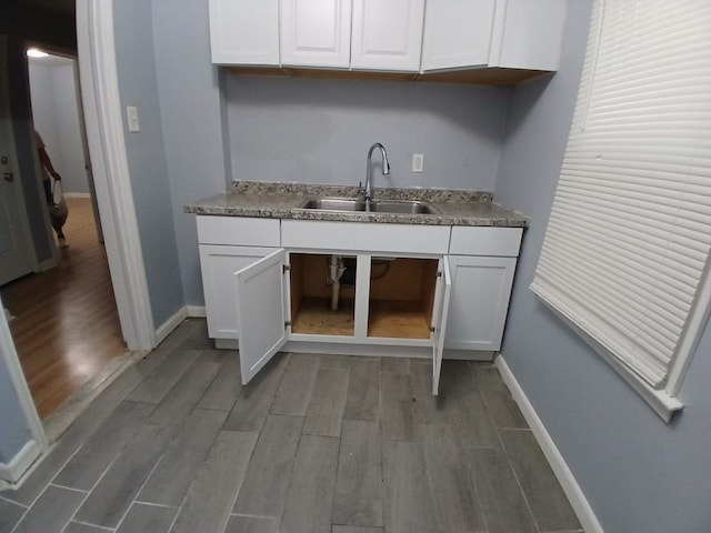 kitchen featuring sink and white cabinetry