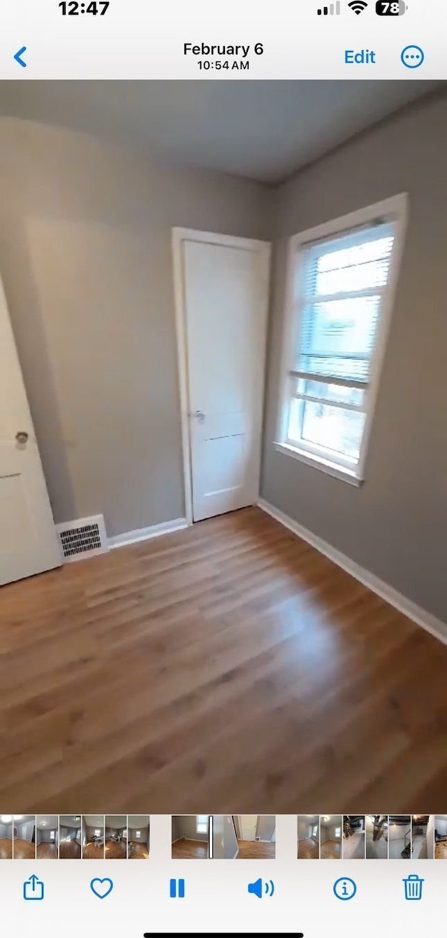 empty room with hardwood / wood-style floors