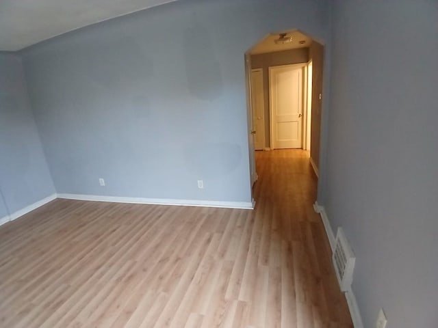 unfurnished room with light wood-type flooring