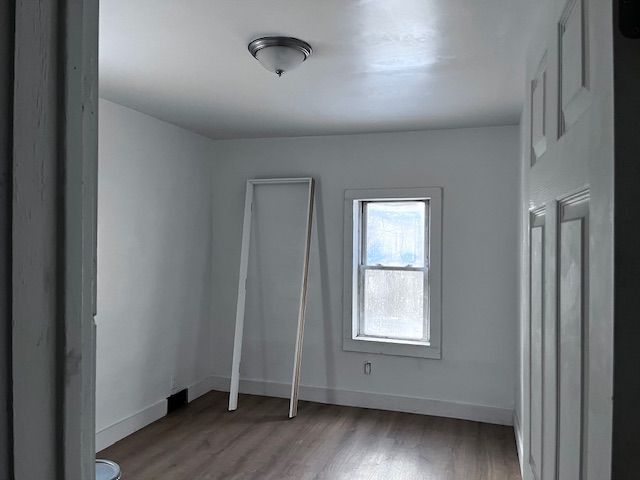 unfurnished room featuring hardwood / wood-style floors