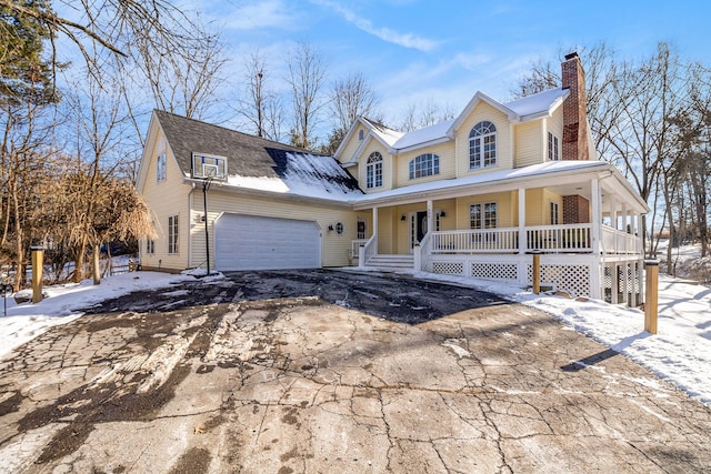 view of front of home with a porch and a garage