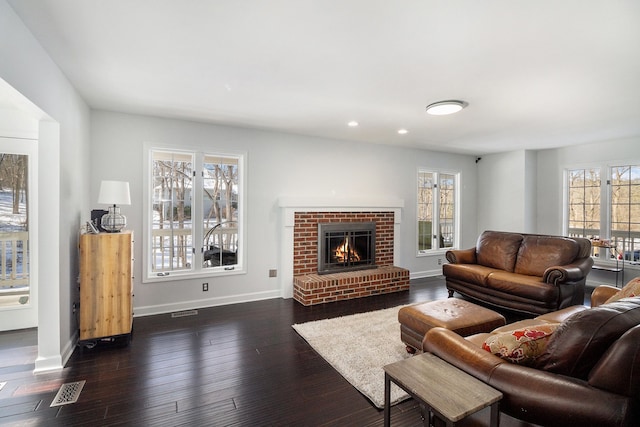 living room featuring dark hardwood / wood-style flooring and a fireplace