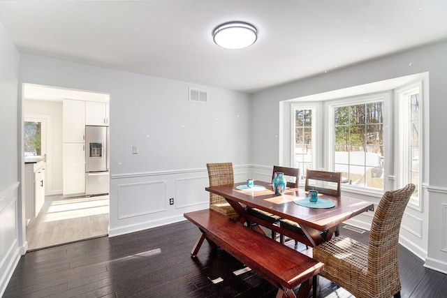 dining area with dark hardwood / wood-style flooring