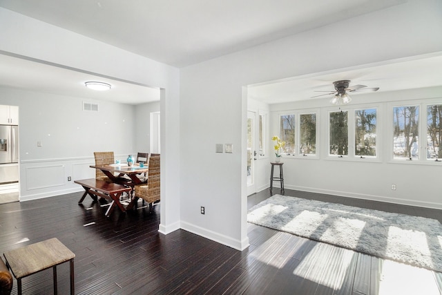 interior space with ceiling fan and dark hardwood / wood-style flooring