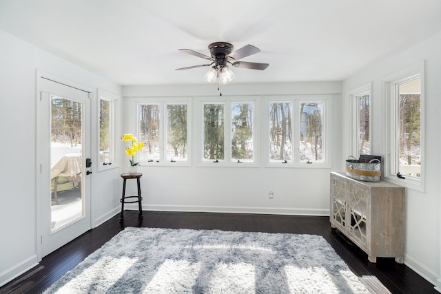 sunroom / solarium featuring plenty of natural light and ceiling fan