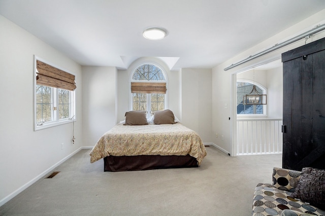 bedroom featuring light carpet and multiple windows