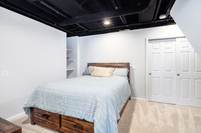 bedroom featuring light colored carpet and a closet