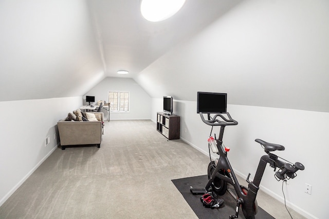 exercise area with light carpet and vaulted ceiling