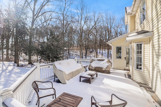 snow covered patio featuring a wooden deck