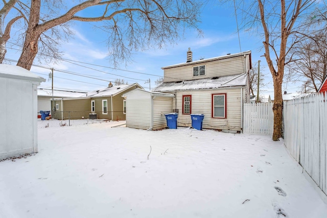 view of snow covered back of property