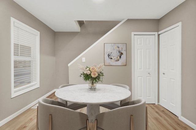 dining space with light wood-type flooring