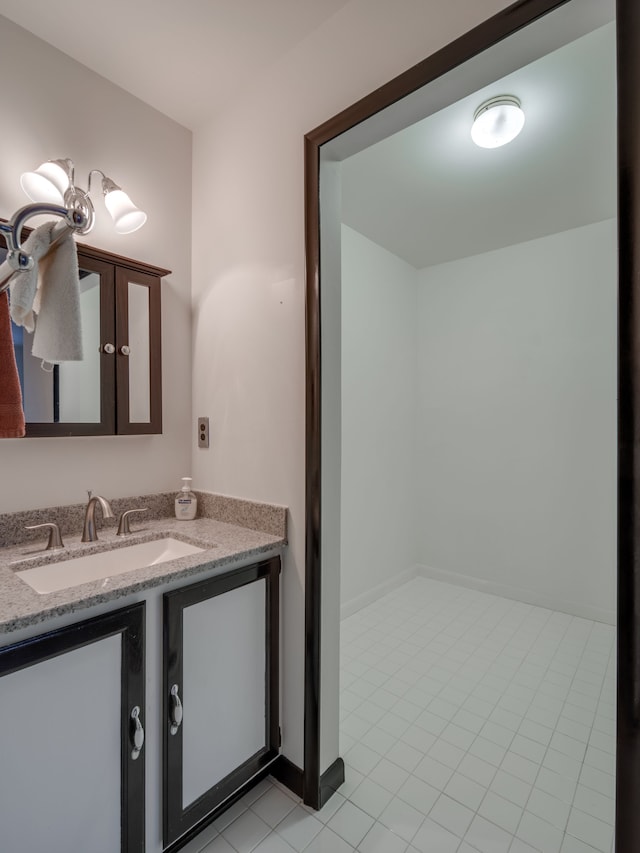 bathroom with tile patterned flooring and vanity