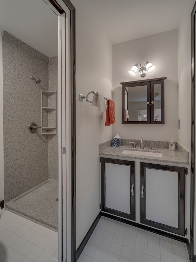 bathroom with vanity, tile patterned floors, and tiled shower