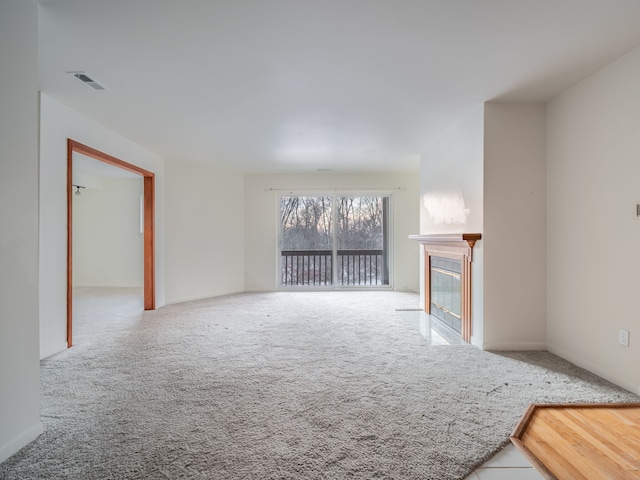 unfurnished living room with carpet flooring