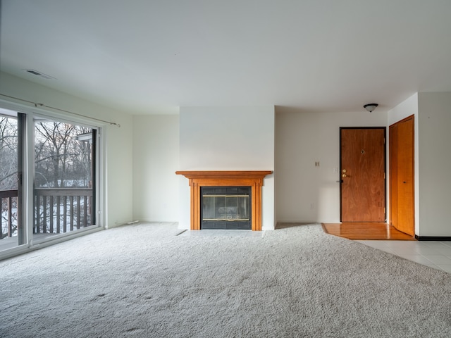 unfurnished living room featuring carpet