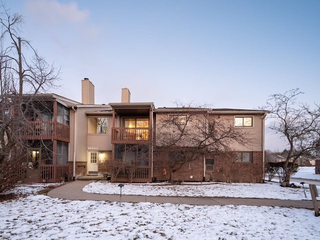 snow covered property featuring a balcony