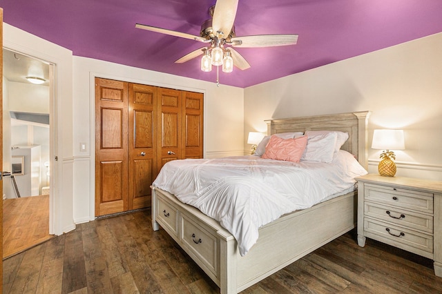 bedroom with dark hardwood / wood-style floors, a closet, and ceiling fan