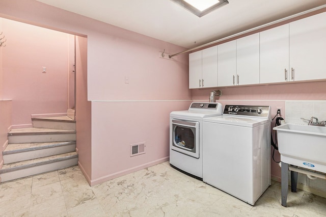 laundry room featuring sink, cabinets, and independent washer and dryer