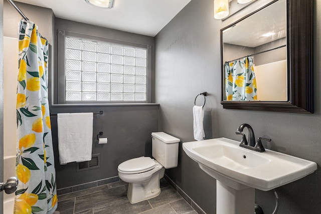 bathroom with sink, toilet, and a shower with shower curtain