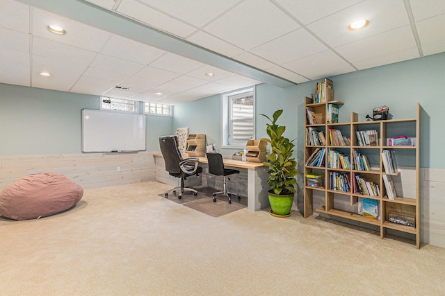 home office with carpet floors and a paneled ceiling