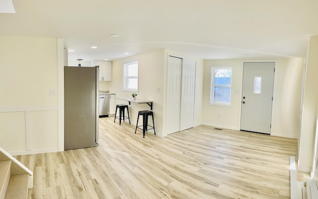 foyer entrance with light hardwood / wood-style flooring