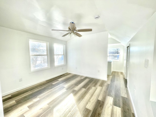 unfurnished room featuring ceiling fan, lofted ceiling, and wood-type flooring