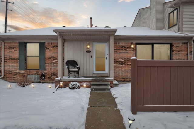 view of snow covered property entrance