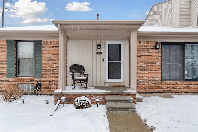 view of snow covered property entrance