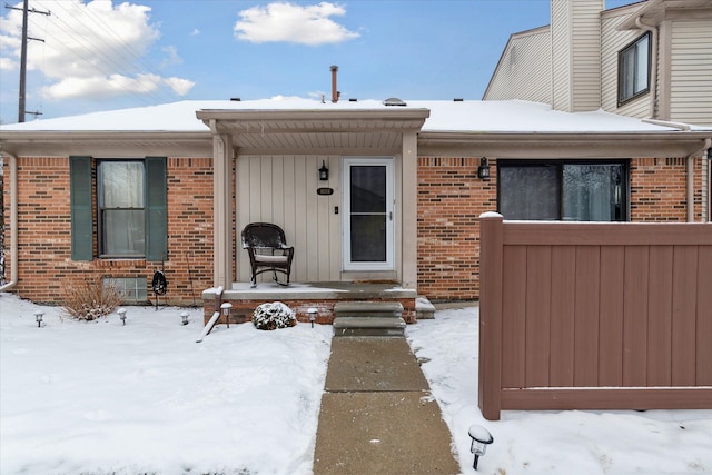 view of snow covered property entrance