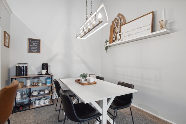 dining area featuring carpet and a notable chandelier