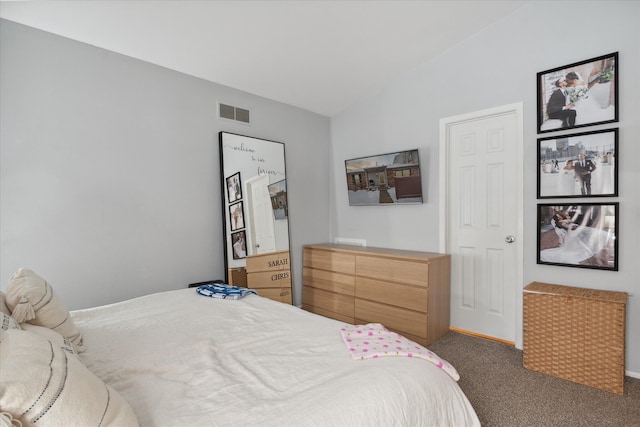 bedroom with vaulted ceiling and dark carpet