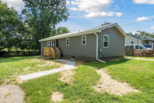 back of house featuring a lawn