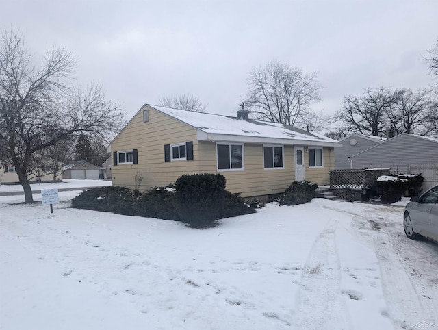 view of snow covered back of property