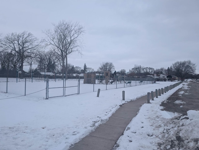 yard layered in snow with a playground