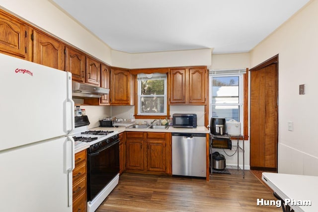 kitchen featuring dark wood-type flooring, sink, and white appliances