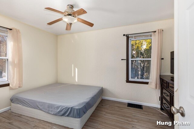 bedroom with ceiling fan and hardwood / wood-style floors