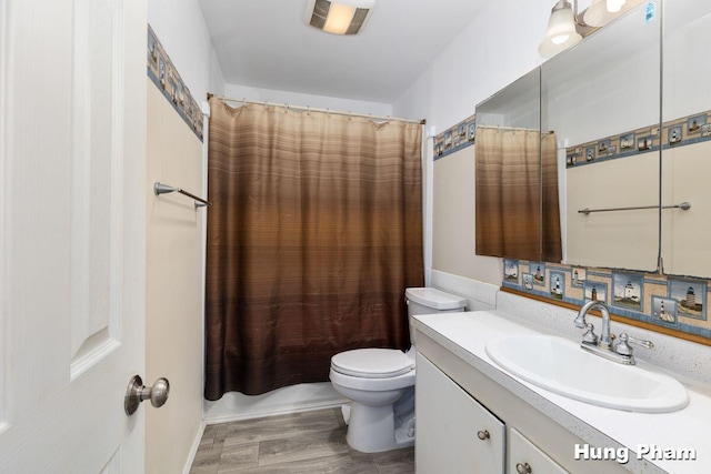 full bathroom with toilet, vanity, shower / bathtub combination with curtain, and hardwood / wood-style flooring